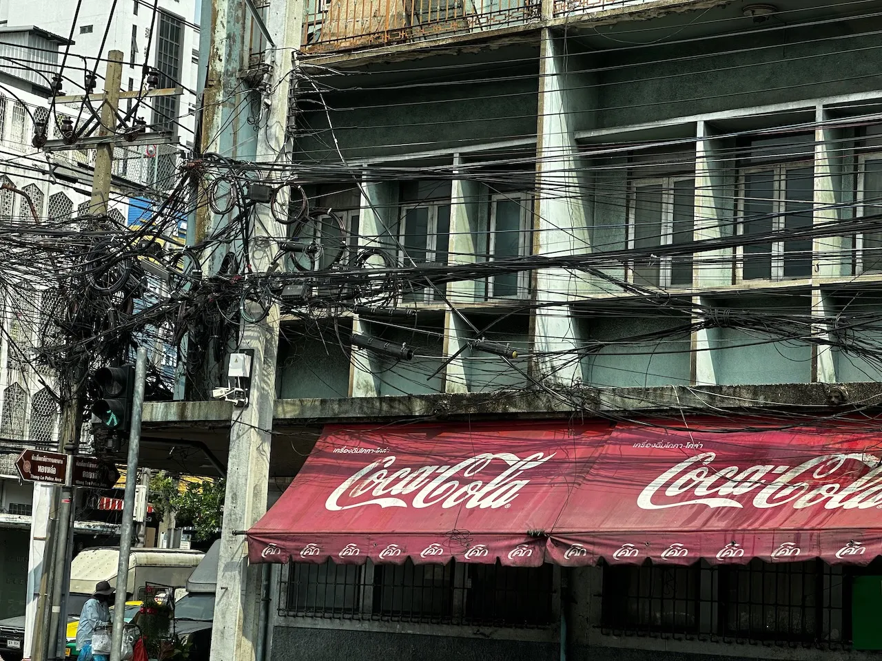 Electricity pole with ton of fiber wires on it even touching ground.